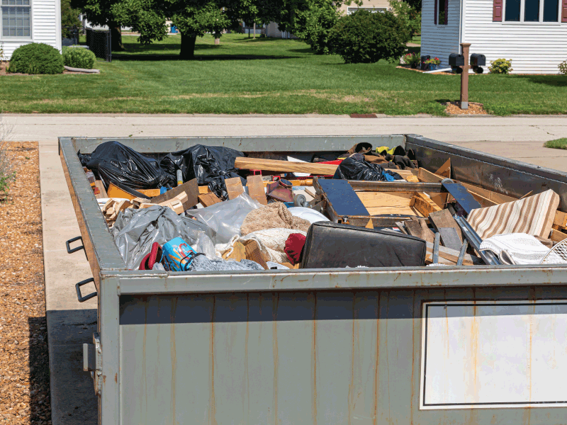 waste inside 10 yard dumpster in driveway
