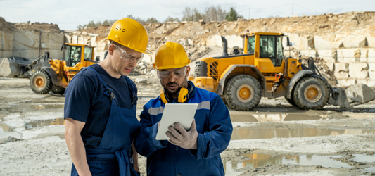 Construction workers looking at blueprint at worksite
