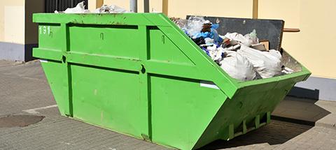 green 20 yard dumpster full of waste