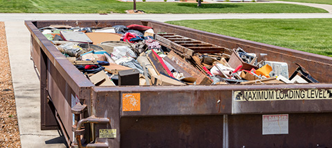 roll-off dumpster filled with trash